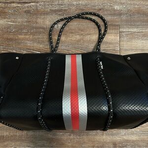 HAUTE SHORE, like NEW, neoprene Black Tote with Red and Silver Stripes.